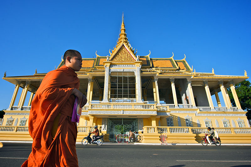 A lone monk walks past Chan Chaya Pavilion at the Royal Palace in central Phnom penh