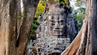 A stone tower of Victory Gate inside Angkor Thom depicts the smiling face of the king portrayed as Boddhisattava Avalokitesvara (Buddha)