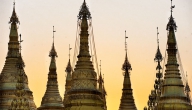 The golden spires of Shwedagon Pagoda glowing at sunset