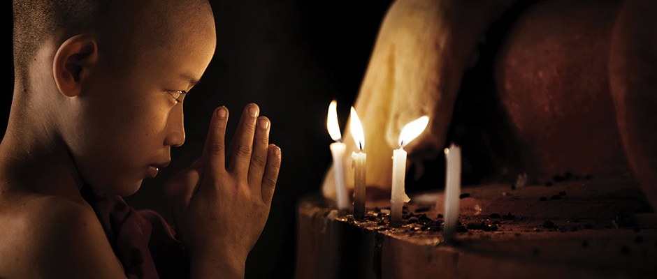 Novice Buddhist Monk, Praying by Candlelight